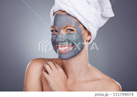 Clay, makeup and woman with mask for portrait facial, healthy beauty spa and studio background. Happy female model, charcoal skincare product and face cosmetics for acne, shower or aesthetic wellness 131799079