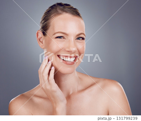 Beauty, face and woman in portrait with hand touching facial, dermatology and skincare on studio background. Cosmetic care, happy model and healthy skin with smile, natural cosmetics and wellness 131799239