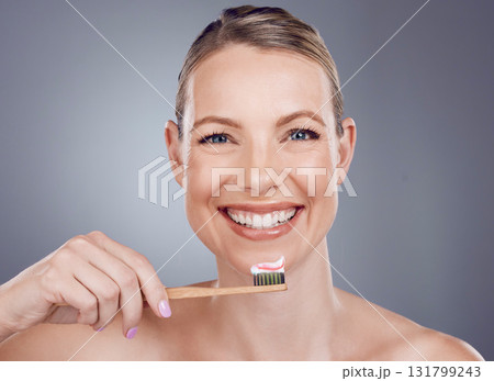 Bamboo toothbrush, toothpaste and portrait of woman for dental wellness, healthy cleaning or face cosmetics. Happy female teeth, eco wooden brush and mouth of smile, mature model or studio background Bamboo toothbrush, toothpaste and portrait of woman for dental wellness, healthy cleaning or face cosmetics. Happy female teeth, eco wooden brush and mouth of smile, mature model or studio background 131799243