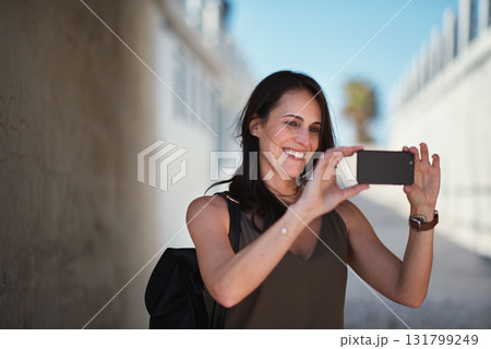Travel, selfie and woman in a city, happy and smile while sightseeing, explore and adventure. Social media, profile picture and influencer blog post by girl in town live streaming to online followers 131799249