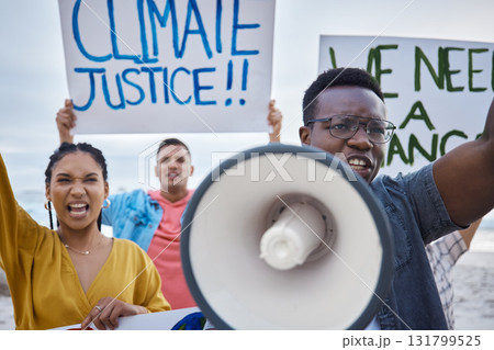 Climate change sign, protest and black man with megaphone for freedom movement. Angry, crowd screaming and young people by the sea with world support for global, social and equality action at beach 131799525