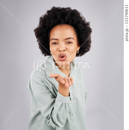 Portrait, woman and blowing kiss in studio, white background and backdrop of love, care or flirt. Face of happy female model, hands and kissing emoji for romance, happiness or smile on valentines day Portrait, woman and blowing kiss in studio, white background and backdrop of love, care or flirt. Face of happy female model, hands and kissing emoji for romance, happiness or smile on valentines day 131799611
