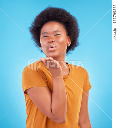 Portrait, black woman and blowing kiss on blue background of love, care and flirting in studio, color backdrop and face. Happy female model, hand kisses and emotion of happiness, fun or kissing emoji Portrait, black woman and blowing kiss on blue background of love, care and flirting in studio, color backdrop and face. Happy female model, hand kisses and emotion of happiness, fun or kissing emoji 131799835