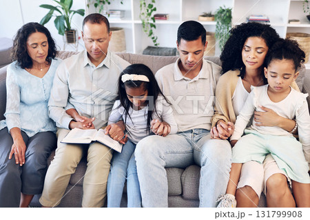 Religious, religion and family praying together in a home or house and praise God for peace, calm and soul. Gratitude, spiritual and people with hope and pray for forgiveness sitting on couch or sofa 131799908