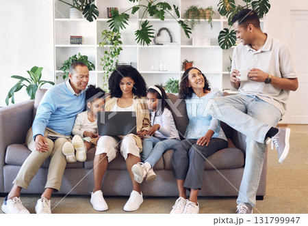 Home, big family and laptop on couch learning with online education, games or movie. Parents, grandparents and children relax together on sofa with internet for quality time streaming and bonding 131799947