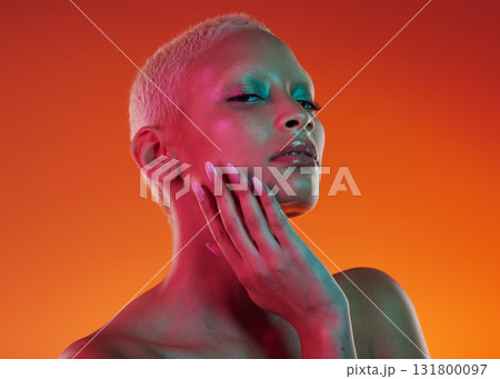 Skincare, beauty and portrait woman with neon face makeup and light in creative advertising on orange background. Cyberpunk, art and model isolated for skin care and futuristic mockup space in studio Skincare, beauty and portrait woman with neon face makeup and light in creative advertising on orange background. Cyberpunk, art and model isolated for skin care and futuristic mockup space in studio 131800097