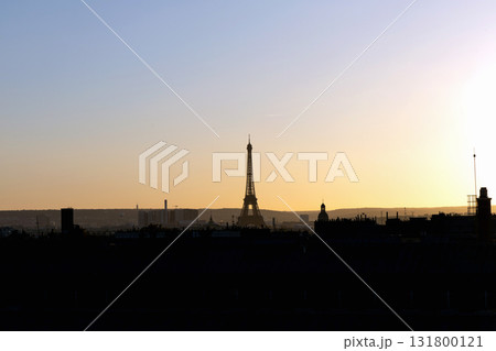 Stunning view of the Eiffel Tower and silhouettes of houses at sunset 131800121