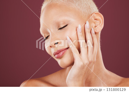 Makeup, hands and face of woman in studio, soft and beauty cosmetics, natural and maroon or red background. Skincare, results and girl model relax in luxury pamper treatment while isolated on mockup. Makeup, hands and face of woman in studio, soft and beauty cosmetics, natural and maroon or red background. Skincare, results and girl model relax in luxury pamper treatment while isolated on mockup. 131800129