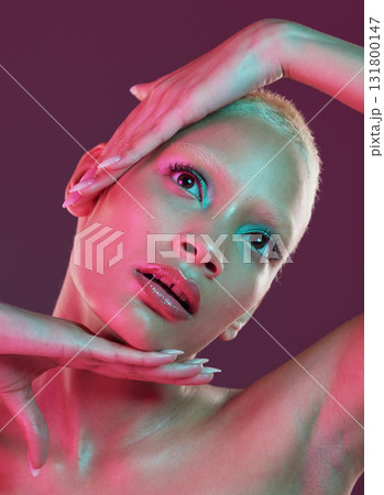 Creative, beauty and art, woman with neon makeup and lights for skincare advertising on studio background. Cyberpunk face, fantasy and model isolated for skin care and futuristic mock up space. 131800147