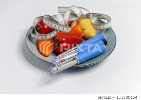 Ozempic Insulin injection pen for diabetics and weight loss on plate with vegetables 131800154
