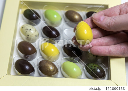 Female hands holding chocolate Easter egg 131800188