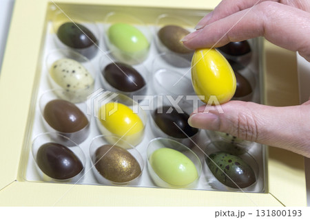 Female hands holding chocolate Easter egg Female hands holding chocolate Easter egg 131800193