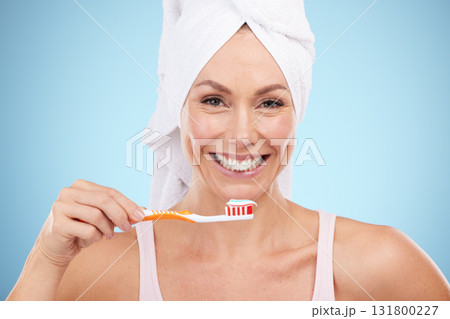 Mature woman, portrait and brushing teeth isolated on blue background dental, mouth or orthodontics healthcare. Beauty model or face of happy person with toothbrush product and toothpaste in studio 131800227
