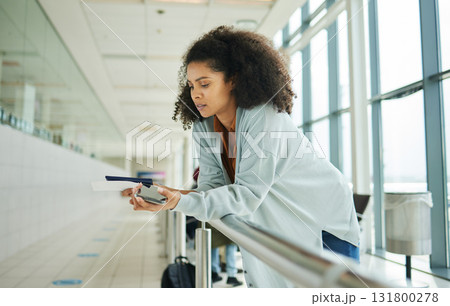 Ticket, airport and passport of black woman for travel, global opportunity and transport time or schedule. UK person with smartphone and identity document in lobby for flight services and immigration 131800278