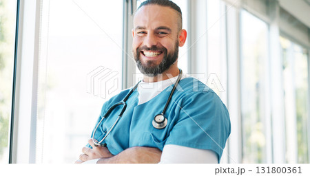 Doctor in portrait, man with arms crossed and healthcare, smile with confidence at hospital with pride and help. Happy medical professional, trust and expert at clinic with scrubs and medicine 131800361