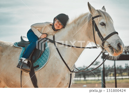 Horse riding, young equestrian and portrait of a girl on a animal in the countryside. Farm, summer and horses training outdoor on farming field with a happy kid smile learning to ride for sport Horse riding, young equestrian and portrait of a girl on a animal in the countryside. Farm, summer and horses training outdoor on farming field with a happy kid smile learning to ride for sport 131800424