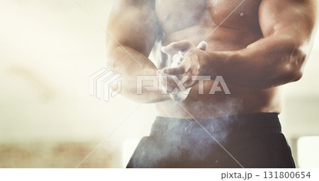 Hands, sports and powder dust in gym for grip, workout and exercise for wellness. Fitness, health and man, bodybuilder or male athlete clapping with chalk and ready to start training for muscles. Hands, sports and powder dust in gym for grip, workout and exercise for wellness. Fitness, health and man, bodybuilder or male athlete clapping with chalk and ready to start training for muscles. 131800654