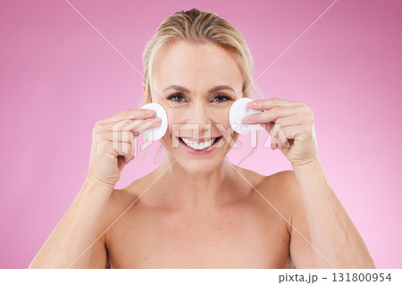 Beauty, skin care and woman portrait with cotton in studio for cosmetics, makeup and dermatology. Happy mature model person on pink background for luxury facial detox and cleaning product on face 131800954