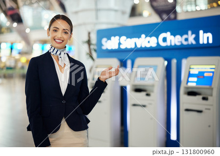 Woman, passenger assistant and airport for check in by self service station or machine for information, help or FAQ. Portrait of happy female services agent standing ready to assist people in travel Woman, passenger assistant and airport for check in by self service station or machine for information, help or FAQ. Portrait of happy female services agent standing ready to assist people in travel 131800960