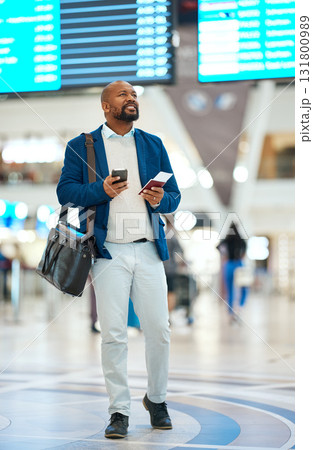 Black man checking flight schedule with phone and ticket walking in airport terminal, holding passport for business trip. Smile, travel app and happy businessman boarding international destination. Black man checking flight schedule with phone and ticket walking in airport terminal, holding passport for business trip. Smile, travel app and happy businessman boarding international destination. 131800989