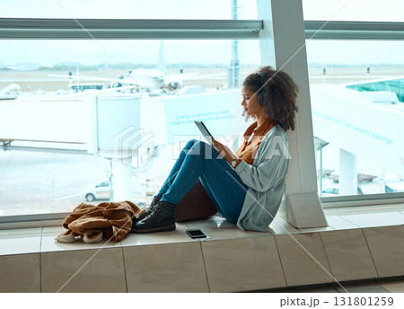 Airport, travel and black woman with tablet by window waiting for global flight, departure and transport. International plane, lobby and girl with digital tech for internet, schedule and social media Airport, travel and black woman with tablet by window waiting for global flight, departure and transport. International plane, lobby and girl with digital tech for internet, schedule and social media 131801259
