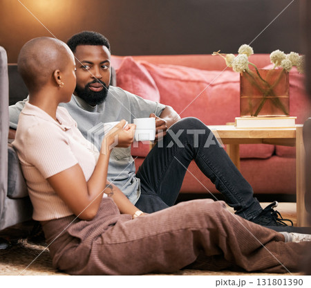 Coffee, love and valentines day with a black couple sitting on the living room floor together for romance. Relax, date or romantic with a man and woman spending time in their home for bonding 131801390