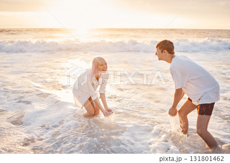 Couple at beach, splash in water with sea, travel and freedom outdoor, love and care in relationship with youth. Cafe free at sunset, nature and ocean waves with young people on holiday in Hawaii Couple at beach, splash in water with sea, travel and freedom outdoor, love and care in relationship with youth. Cafe free at sunset, nature and ocean waves with young people on holiday in Hawaii 131801462