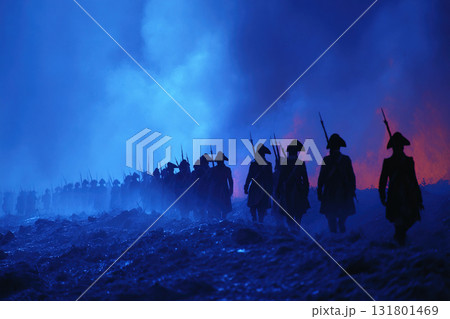 Marching soldiers advance through smoke during a dramatic battle scene at night 131801469