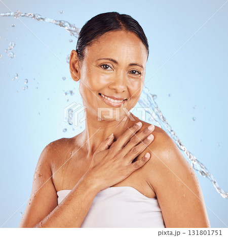 Senior woman, water splash and beauty portrait, hygiene and sustainable skincare for antiaging on blue background. Hand, clean and female smile, eco friendly dermatology and cosmetic care in studio 131801751