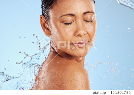 Water splash, skincare and woman on blue studio background health, wellness and hygiene with cleaning routine. Shower, cosmetic beauty and relax, mature model in skin care or dermatology treatment. Water splash, skincare and woman on blue studio background health, wellness and hygiene with cleaning routine. Shower, cosmetic beauty and relax, mature model in skin care or dermatology treatment. 131801780