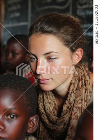 European teacher engaging with children in African school during volunteer experience 131802003