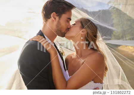 Couple, wedding and kissing with vail for love, compassion or affection together in nature. Married man kiss woman on lips, hugging in marriage, relationship or loving embrace for commitment outdoors Couple, wedding and kissing with vail for love, compassion or affection together in nature. Married man kiss woman on lips, hugging in marriage, relationship or loving embrace for commitment outdoors 131802272
