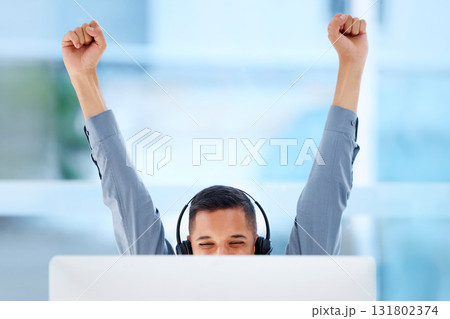 Happy, success and a man in call center with a win, celebration and target achievement on a pc. Smile, excited and a customer support agent celebrating a promotion, bonus or telemarketing goal 131802374