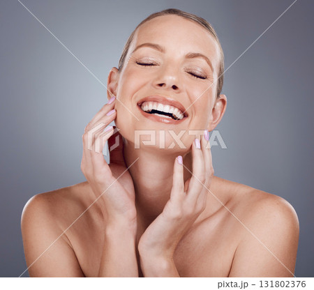 Happy, beauty and skincare with face of woman for facial, cosmetics and spa treatment. Smile, dermatology and wellness with model and glow for self care, clean and makeup in gray studio background Happy, beauty and skincare with face of woman for facial, cosmetics and spa treatment. Smile, dermatology and wellness with model and glow for self care, clean and makeup in gray studio background 131802376