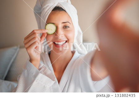 Woman, spa and selfie with cucumber on eye in comic portrait for wellness, self care and relax. Girl, fruit and face for skincare, health and smile for cosmetics, beauty and natural glow in morning Woman, spa and selfie with cucumber on eye in comic portrait for wellness, self care and relax. Girl, fruit and face for skincare, health and smile for cosmetics, beauty and natural glow in morning 131802435