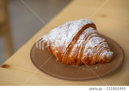 Croissant served on plate, on the wooden table 131802493