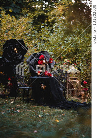 Dark Romantic Still Life with Black Roses and Antique Mirror 131802639
