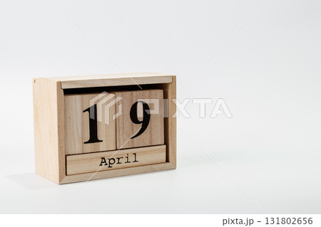 Wooden calendar April 19 on a white background 131802656