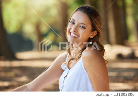 Nature, happy and portrait of a woman in a forest on an outdoor adventure, explore or travel. Happiness, smile and face of a young female model posing in the woods with a positive mindset in summer. 131802806