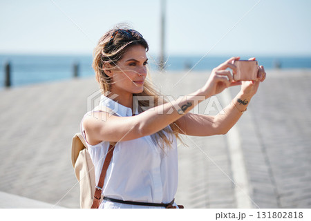 Travel, selfie and woman relax at beach, calm and posing for photo on blurred background. Sightseeing, girl and social media influencer with update post for blog, profile picture or live streaming 131802818