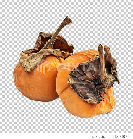 Two ripe persimmons showcase orange skin and wrinkled dry leaves on transparent background 131803079