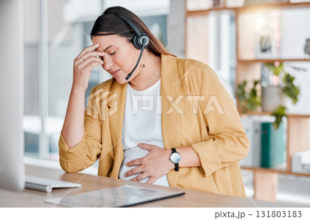Call center, headache and pregnancy, woman at desk with hand on stomach, exhausted in office with headset. Burnout, pain and pregnant telemarketing consultant with anxiety from deadline time stress. Call center, headache and pregnancy, woman at desk with hand on stomach, exhausted in office with headset. Burnout, pain and pregnant telemarketing consultant with anxiety from deadline time stress. 131803183