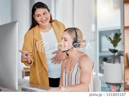 Call center, coaching and pointing at computer in office with pregnant woman, smile and learning at desk. Women, happy manager and desktop with tech support, customer service and workplace education 131803187