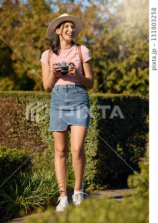 Travel, photography and woman with camera outdoor, happy in nature and picture taking while on holiday in Spain. Adventure, happiness on vacation or influencer with content creation in public garden 131803258