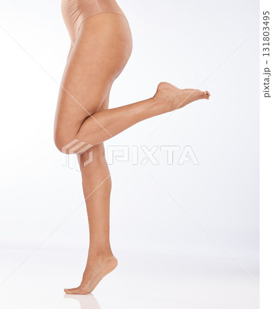 Legs, beauty and black woman with epilation and skincare, laser hair removal with waxing on studio background. Cosmetics, healthy skin and glow with feet, pedicure and spa treatment with dermatology Legs, beauty and black woman with epilation and skincare, laser hair removal with waxing on studio background. Cosmetics, healthy skin and glow with feet, pedicure and spa treatment with dermatology 131803495