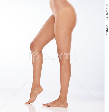 Beauty, epilation and closeup of woman legs in a studio with a shaving, waxing or hair removal routine. Body care, health and female model with a depilation or skin treatment by a white background. Beauty, epilation and closeup of woman legs in a studio with a shaving, waxing or hair removal routine. Body care, health and female model with a depilation or skin treatment by a white background. 131803496
