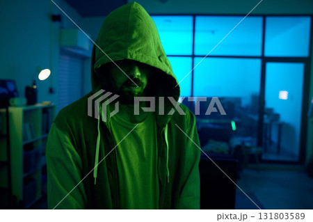 Man, hacking or dark hoodie in neon living room with cybersecurity, software programming or phishing mystery. Hacker, hood or night clothes with secret virus ideas of fraud scam, crime or theft 131803589