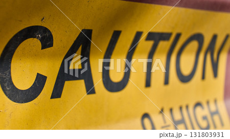 Bright yellow caution sign alerts to danger Bright yellow caution sign alerts to danger 131803931