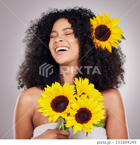 Portrait, cheerful or face of black woman with sunflower in hair in studio for spring time, luxury spa or self care. Aesthetic, happy model or girl model with plant for skincare, cosmetic or makeup Portrait, cheerful or face of black woman with sunflower in hair in studio for spring time, luxury spa or self care. Aesthetic, happy model or girl model with plant for skincare, cosmetic or makeup 131804245