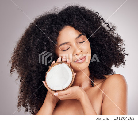 Coconut, beauty and black woman isolated on studio background for natural skincare, face and hair dream. Afro model or young person sleeping with fruit product or healthy oil benefits for dermatology 131804265